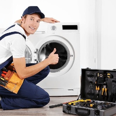 Technician Servicing Washing Machine.